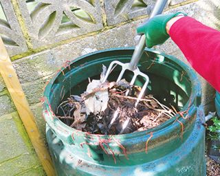 turning compost in a bin