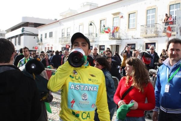 Race winner Alberto Contador takes a swig of champagne.