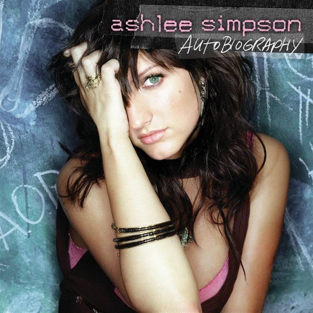 the cover art for ashlee simpson autobiography of her holding her bangs and a blue background