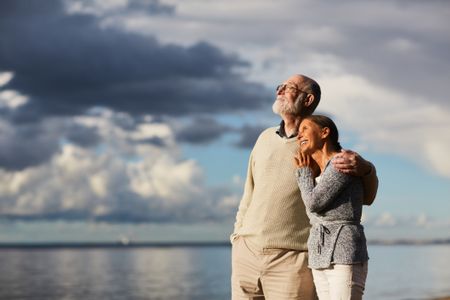 Older couple at the beach in the evening 