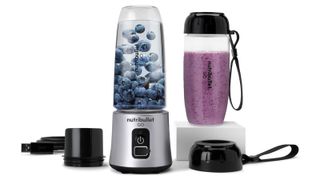 A Nutribullet GO filled with blueberries, making a blueberry smoothie