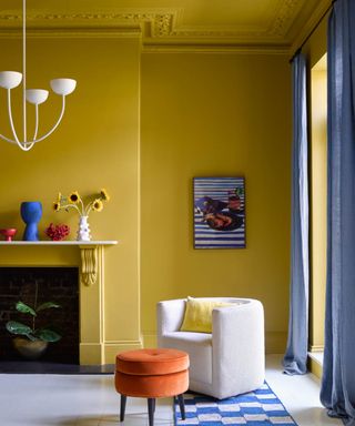 living room with bright yellow walls and blue accent colours