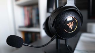 Razer Kraken V3 Hypersense pictured on desk hanging from a stand