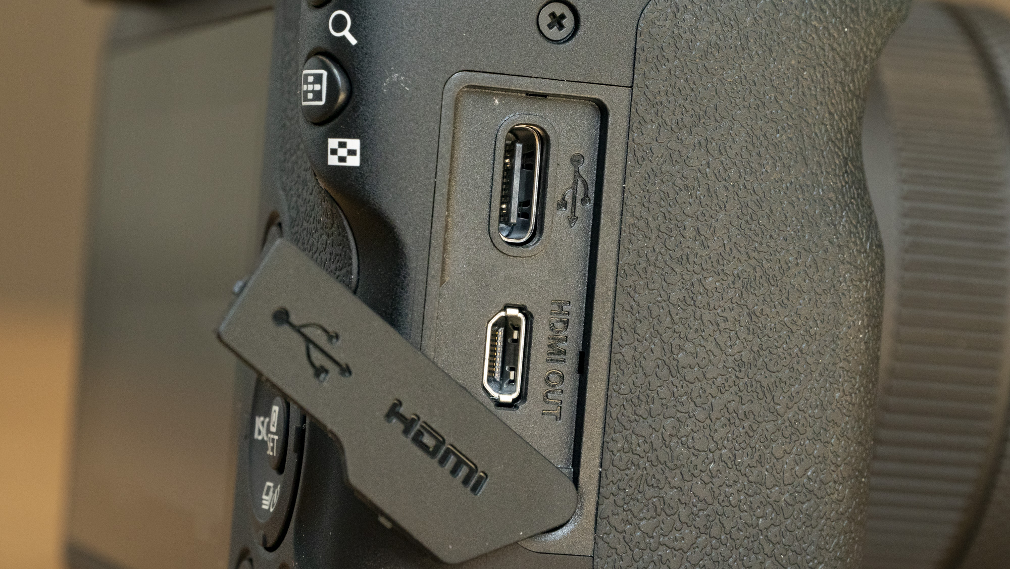 Canon EOS R100 camera on a table closeup of USB-C port