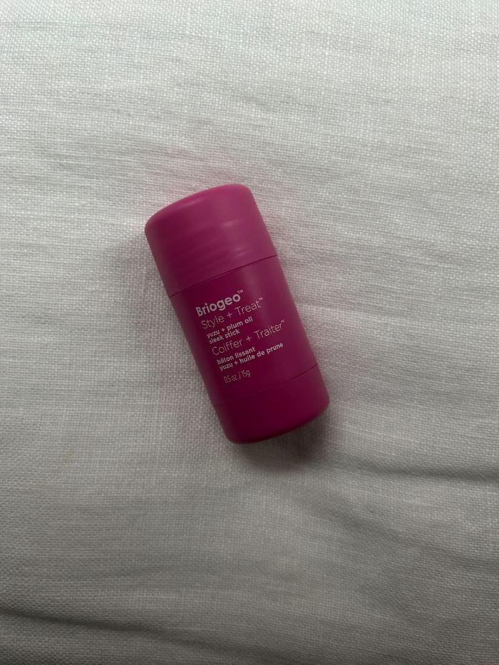 The Briogeo Style + Treat Yuzu + Plum Oil Sleek Stick on a white linen background