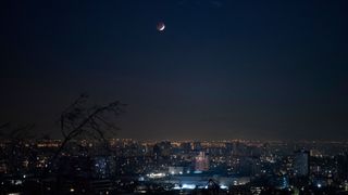 This photo, snapped in Santiago, Chile on May 26, 2021, shows just a sliver of the moon illuminated.