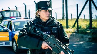 Grace Ellis (Siân Brooke) dressed in full tactical gear and holding a gun in Blue Lights
