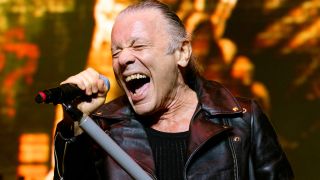 Bruce Dickinson performing onstage with Iron Maiden in 2025