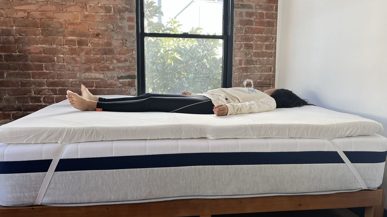 Woman lying on Tempur-Adapt Topper on her back