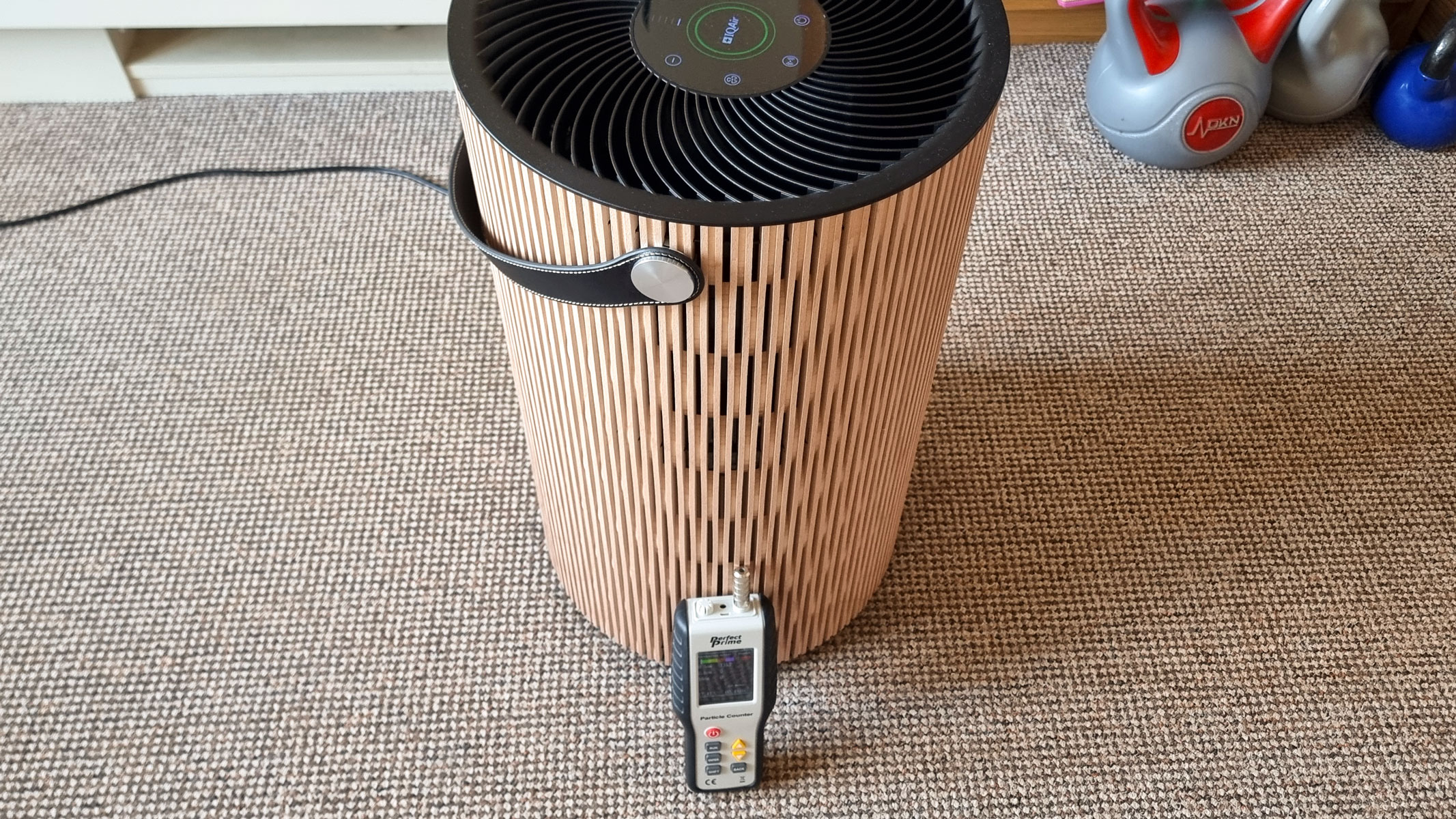 A picture of our reviewer's IQAir Atem Earth air purifier and the Perfect Prime air particle monitor