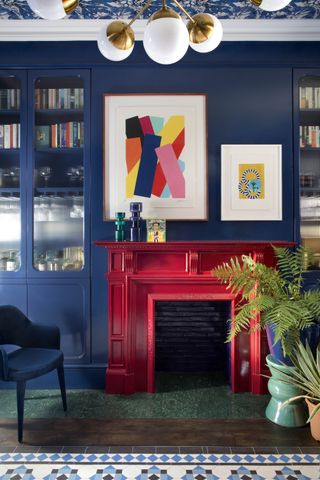 Red fireplace on blue wall