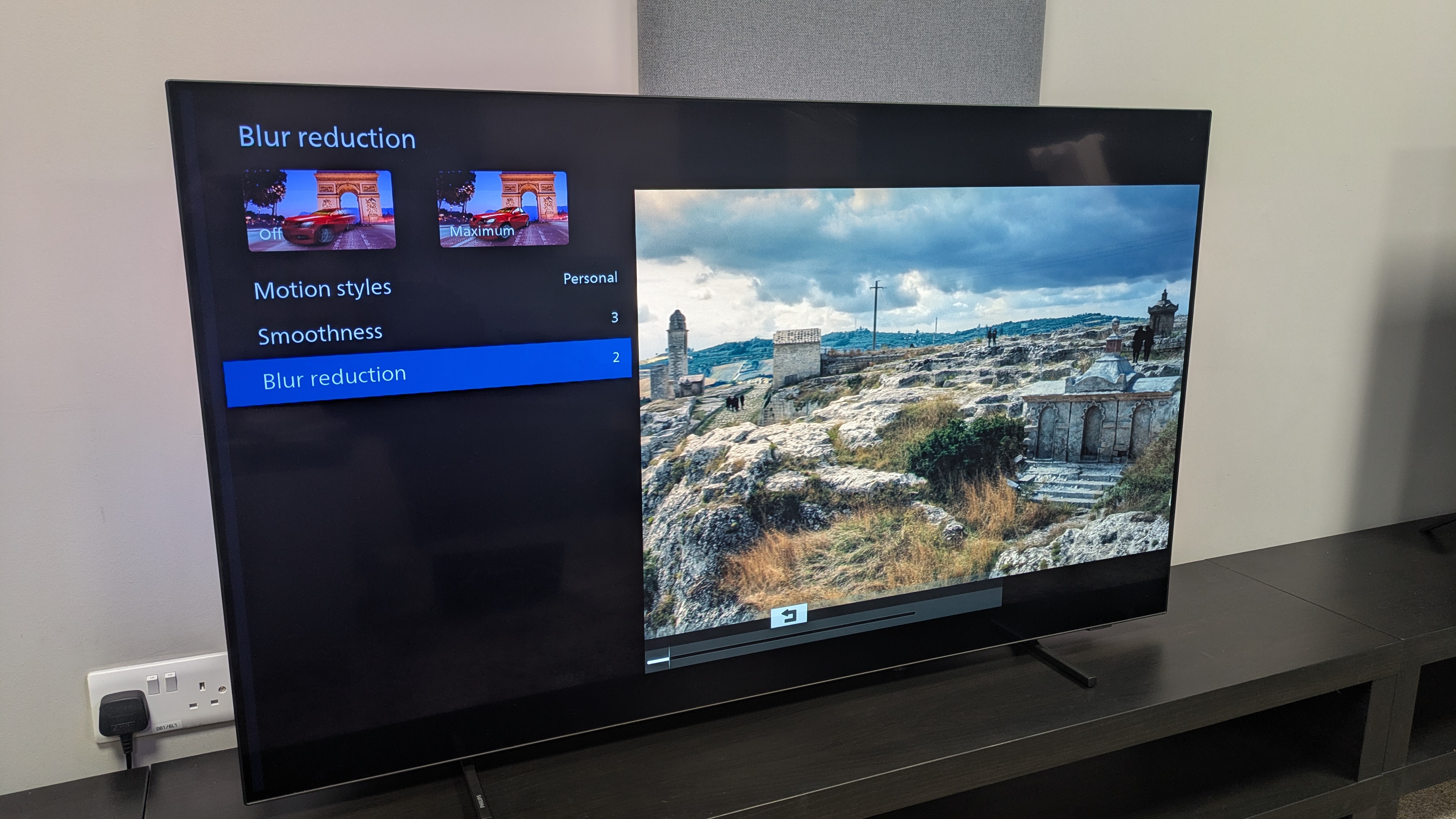 Philips OLED760 with motion smoothing menu on top of No Time To Die on screen 