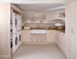 pink large utility room with wooden worktop and laundry appliances