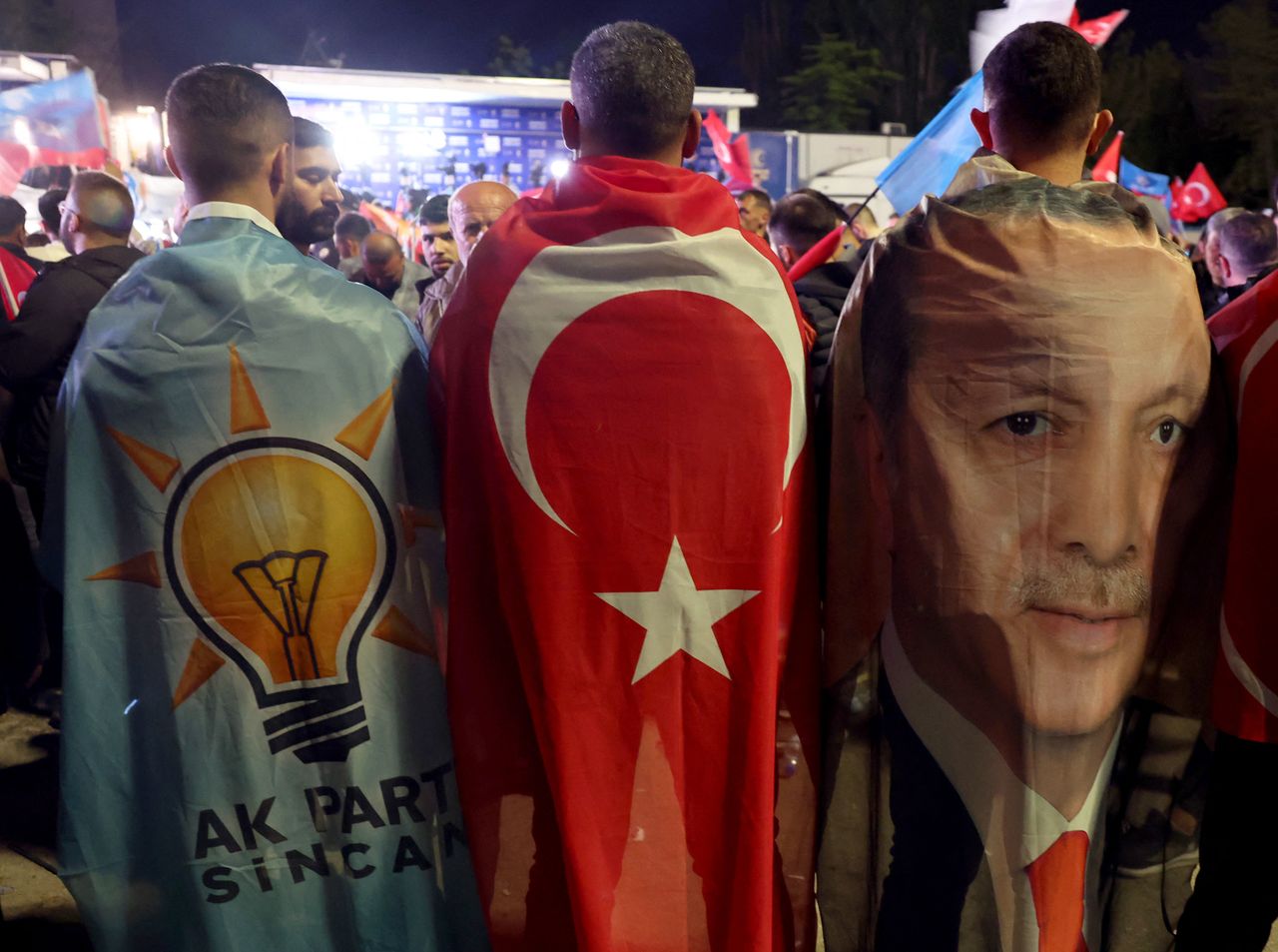 Turkish voters wear flags of the AK Party and showing Erdogan&amp;#039;s face