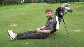 Photo of someone falling asleep on their golf bag