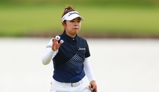 Miyu Yamashita waves to the crowd after holing a putt