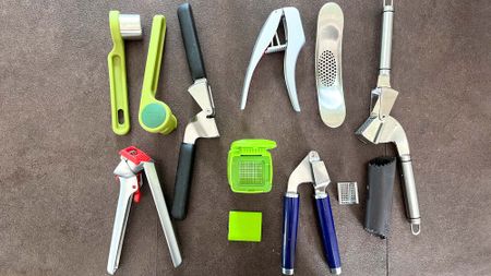 The best garlic presses shown spread on a kitchen counter