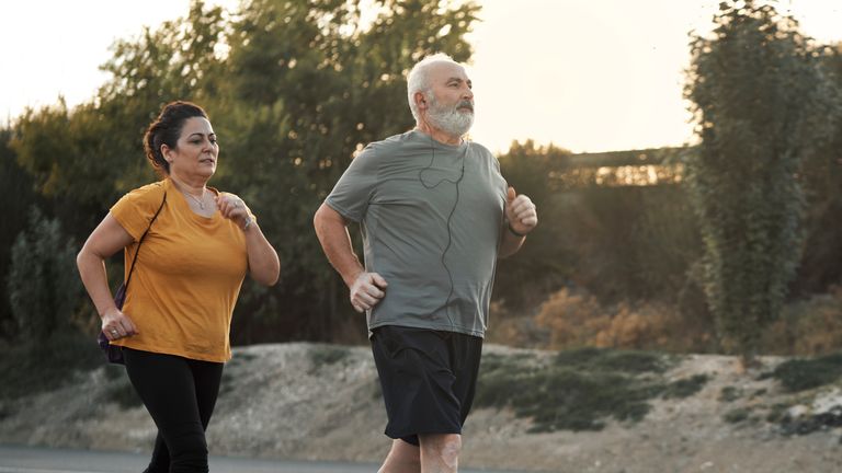 Overweight man and woman jogging