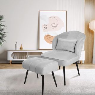 grey velvet chair with matching ottoman in a minimalist living room