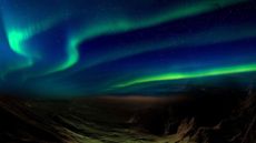 An artist's illustration of long ribbon-like auroras rippling across the Martian sky