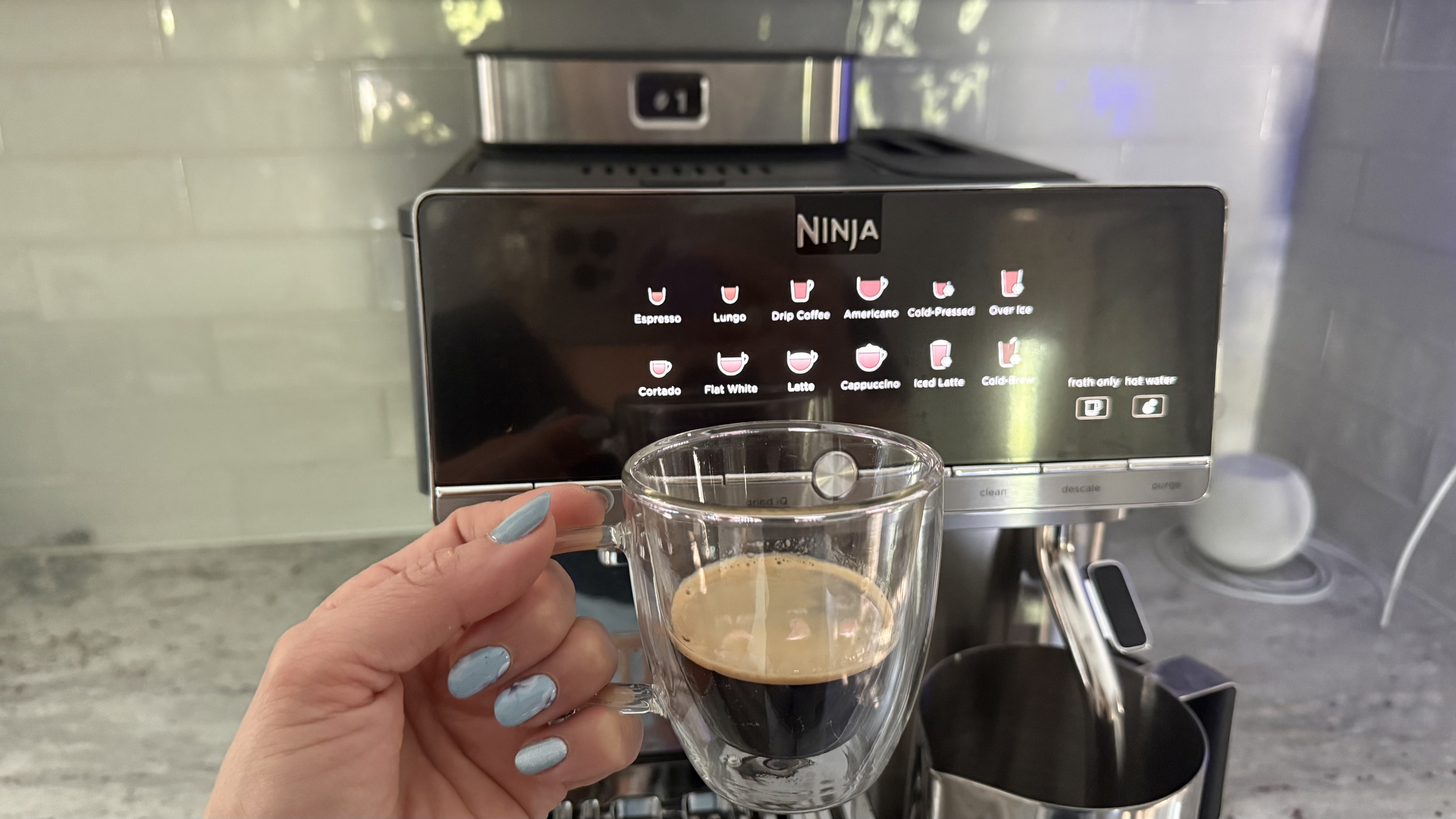 Ninja AutoBarista Pro and espresso in hand