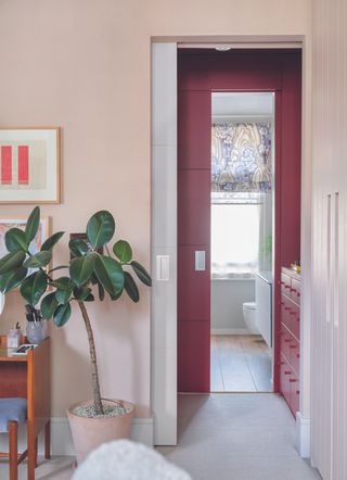View through a sliding doorway from bedroom to en suite bathroom