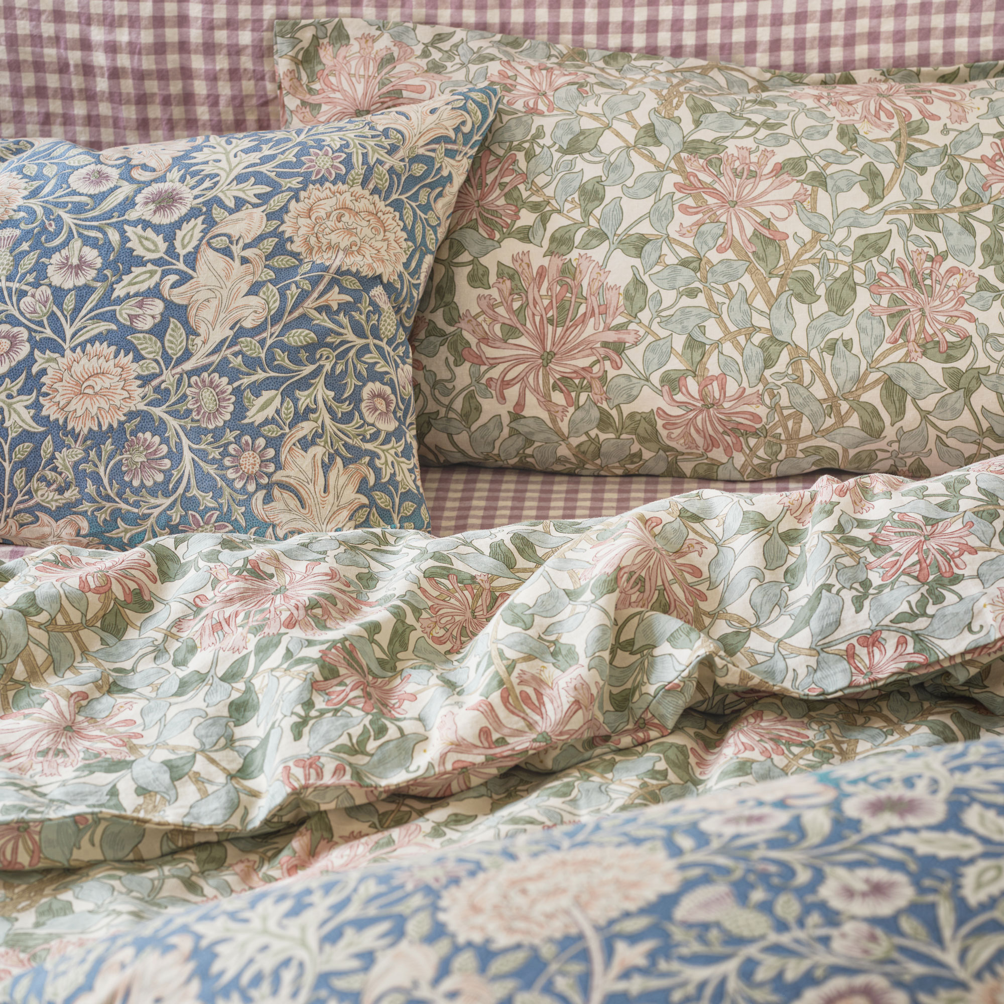 Piglet in Bed Morris and Co bedding in green with red headboard