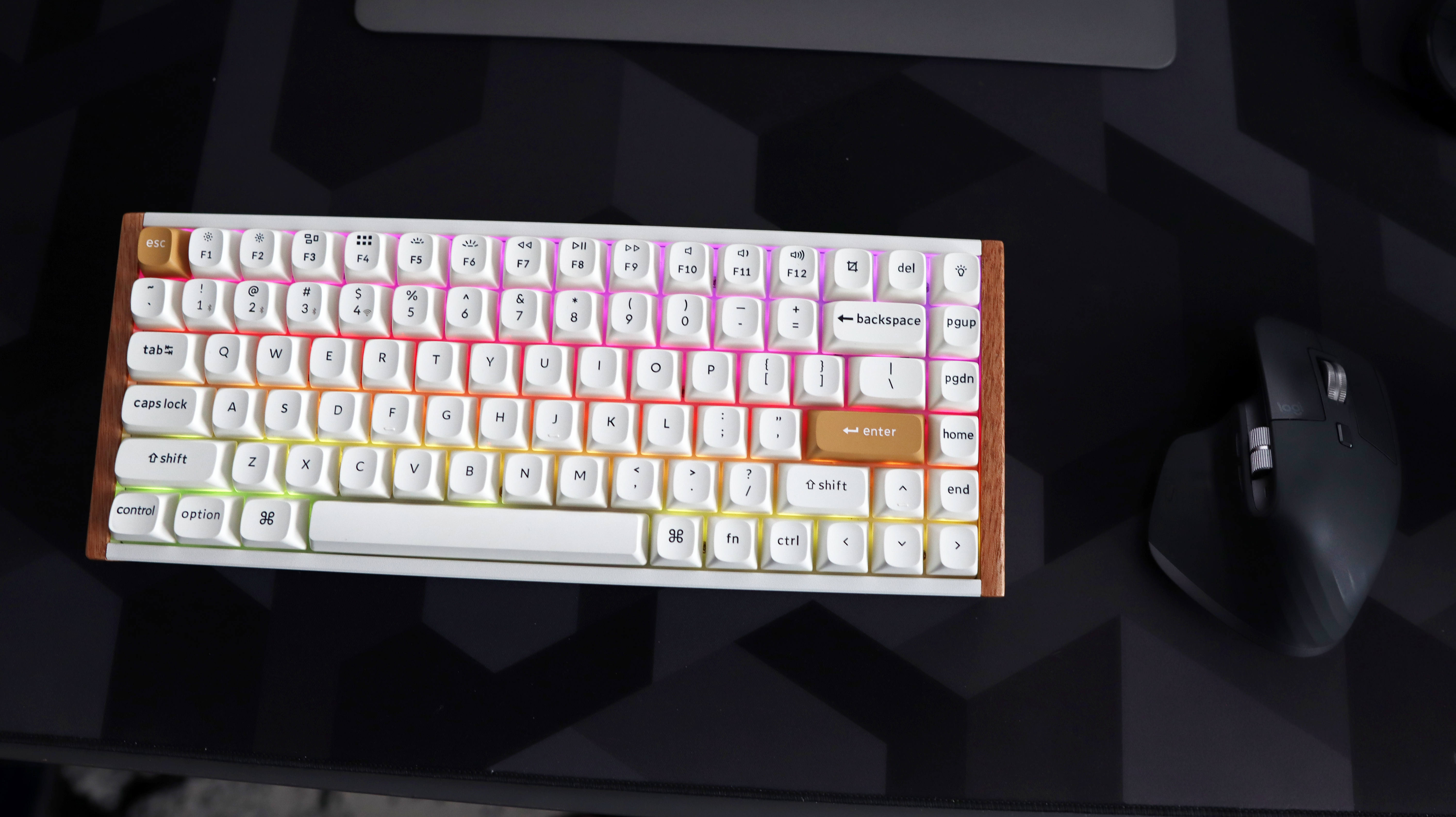 A Keychron K2 HE gaming keyboard with a wood finish and white keycaps with RGB enabled.