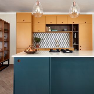 best colour combinations, mustard and teal kitchen with yellow cabinetry, teal kitchen island, glass pedant lights, splash back