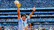 Diego Maradona hoists the FIFA World Cup trophy as he is carried off the field by fans and teammates after the 1986 FIFA World Cup Mexico Final between Argentina and West Germany on June 29th, 1986