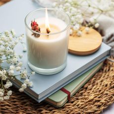 how to make soy candles Aromatic soy candle on the table with notebooks and blanket