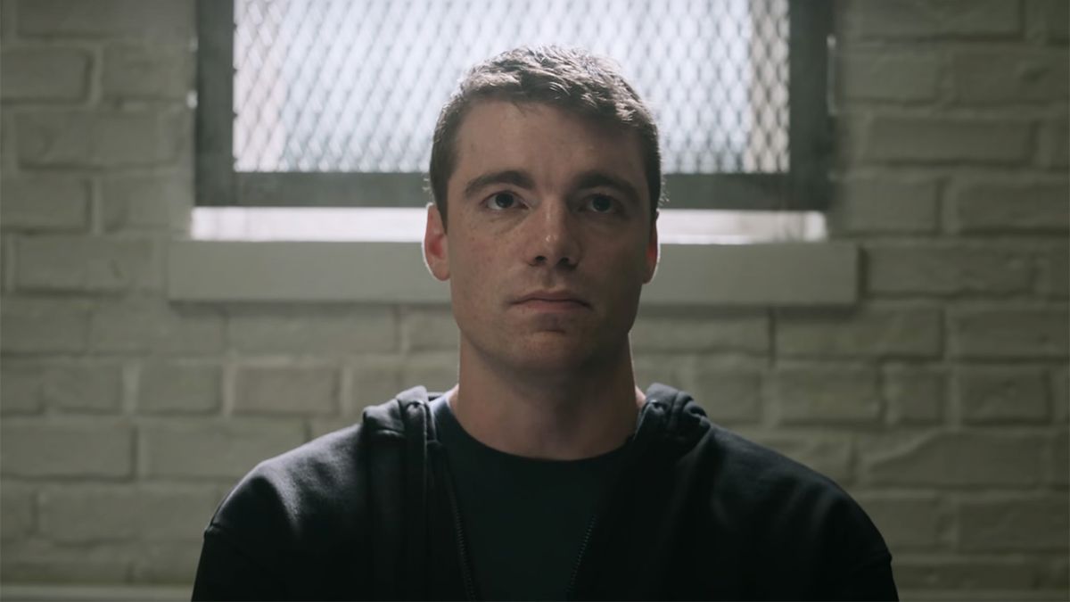 Gabriel Basso&#039;s character Peter Sutherland being held in a stark room with a brick wall and a gated window.