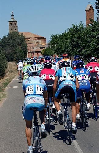 The peloton rolls into a village.