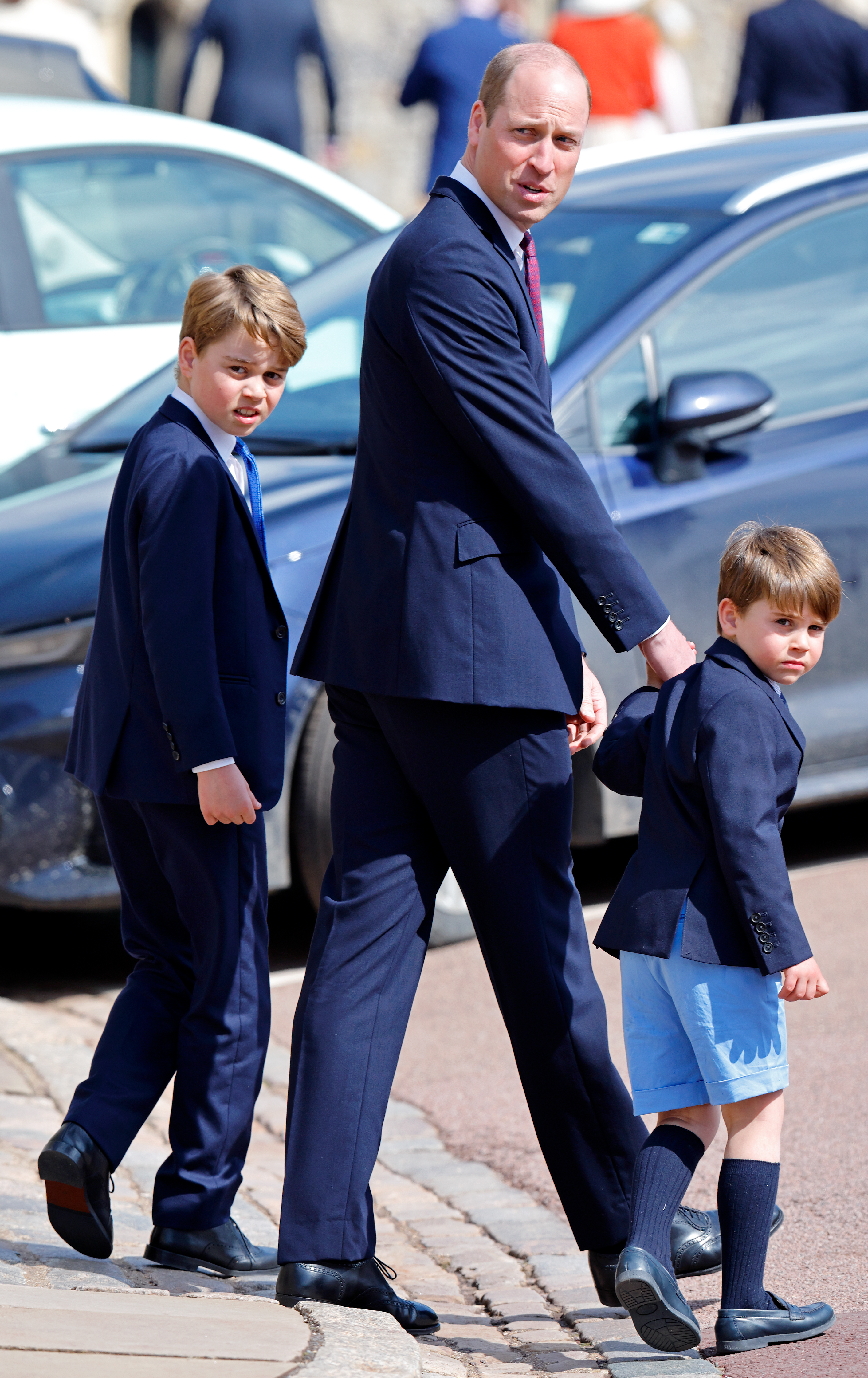Prince George, Prince William, and Prince Louis attend the traditional Easter Sunday Mattins Service at St George's Chapel, Windsor Castle on April 9, 2023, with Louis wearing light blue shorts and knee socks