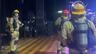 Firefighters inside a music venue in 2024