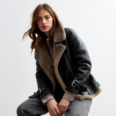 Model wearing a wool lined leather jacket sold at New Look