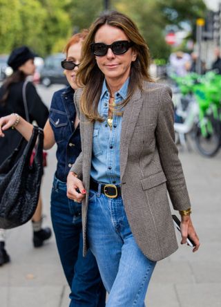 Woman wearing a tweed blazer in London