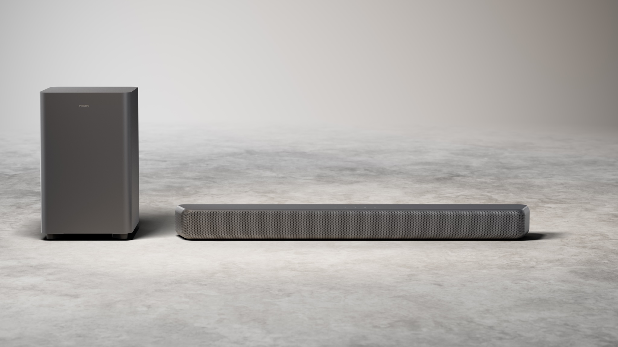 The Philips B5601 soundbar and subwoofer on a grey surface with a grey background