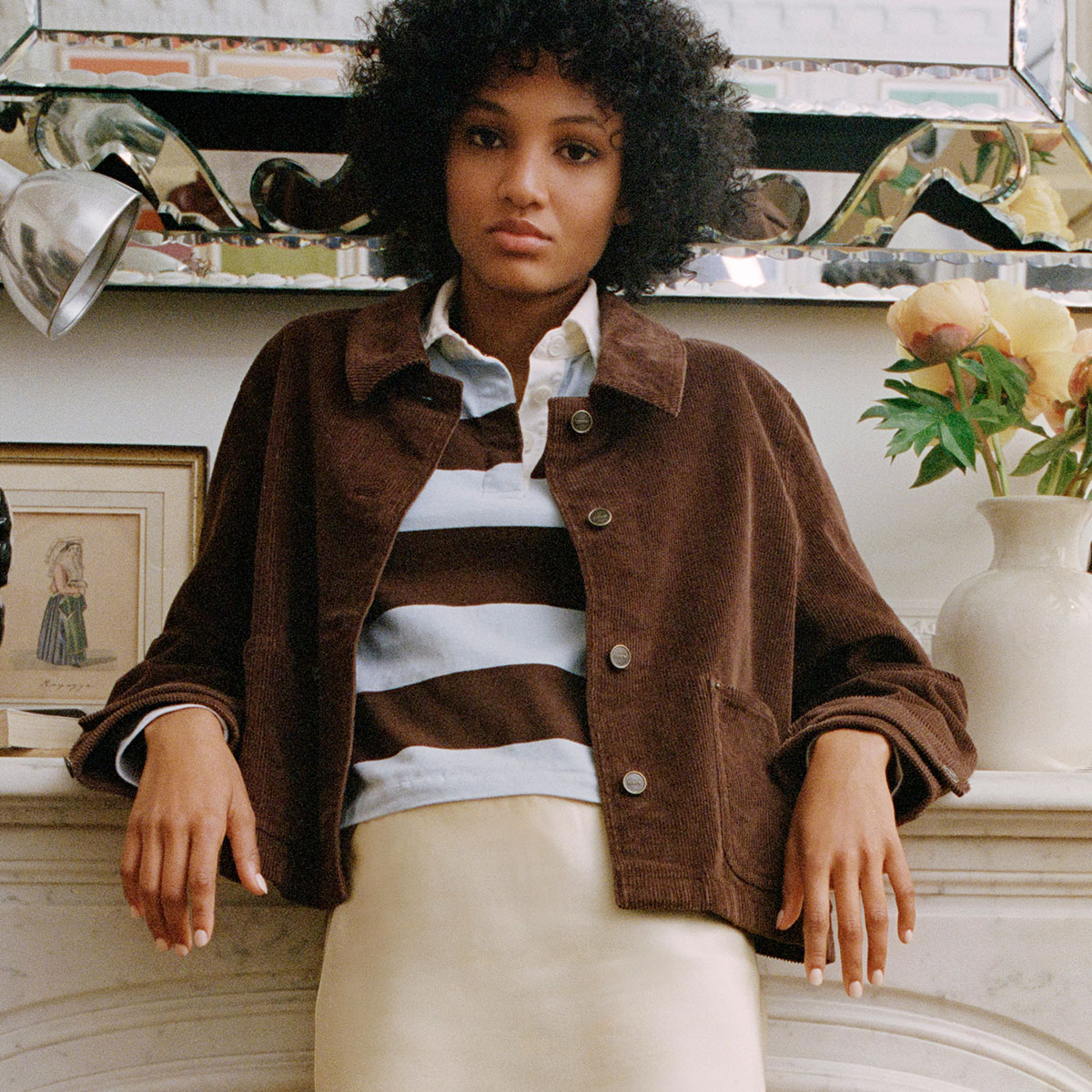 Woman in blazer, sweater, and jeans