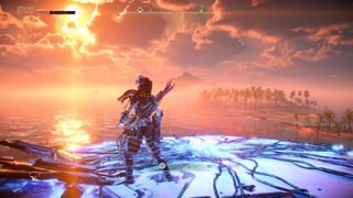 Aloy stands on top of a Tallneck as it walks in the ocean at sunset