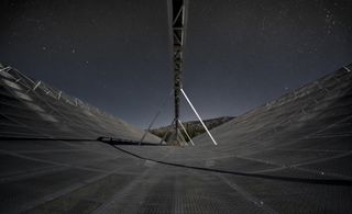 Canada's CHIME radio telescope (seen at night here) recently detected 13 mysterious fast radio bursts (FRBs), including just the second known repeating FRB.