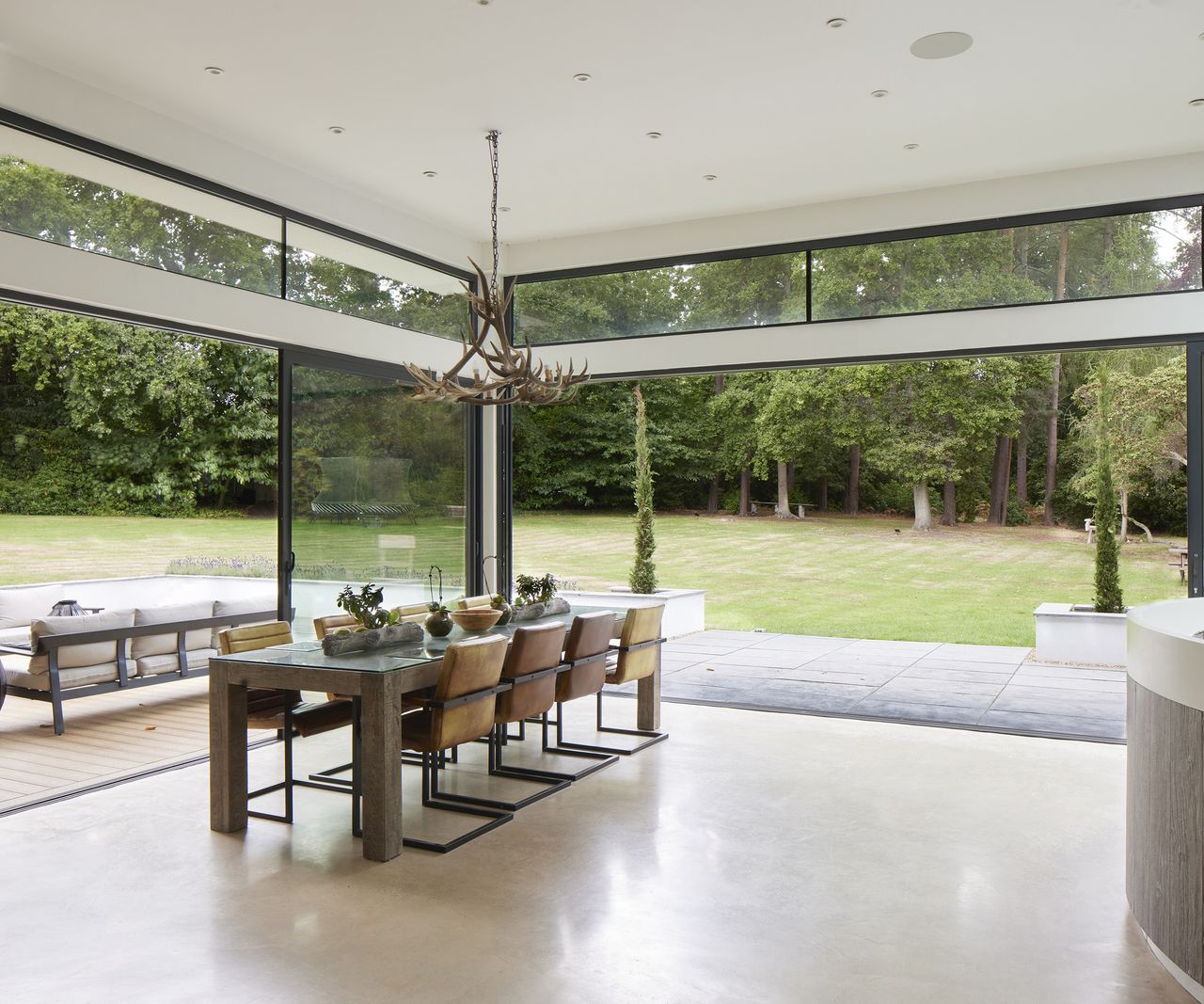 Fully glazed window and sliding door s making up two walls in a new build home creating a seamless view outside