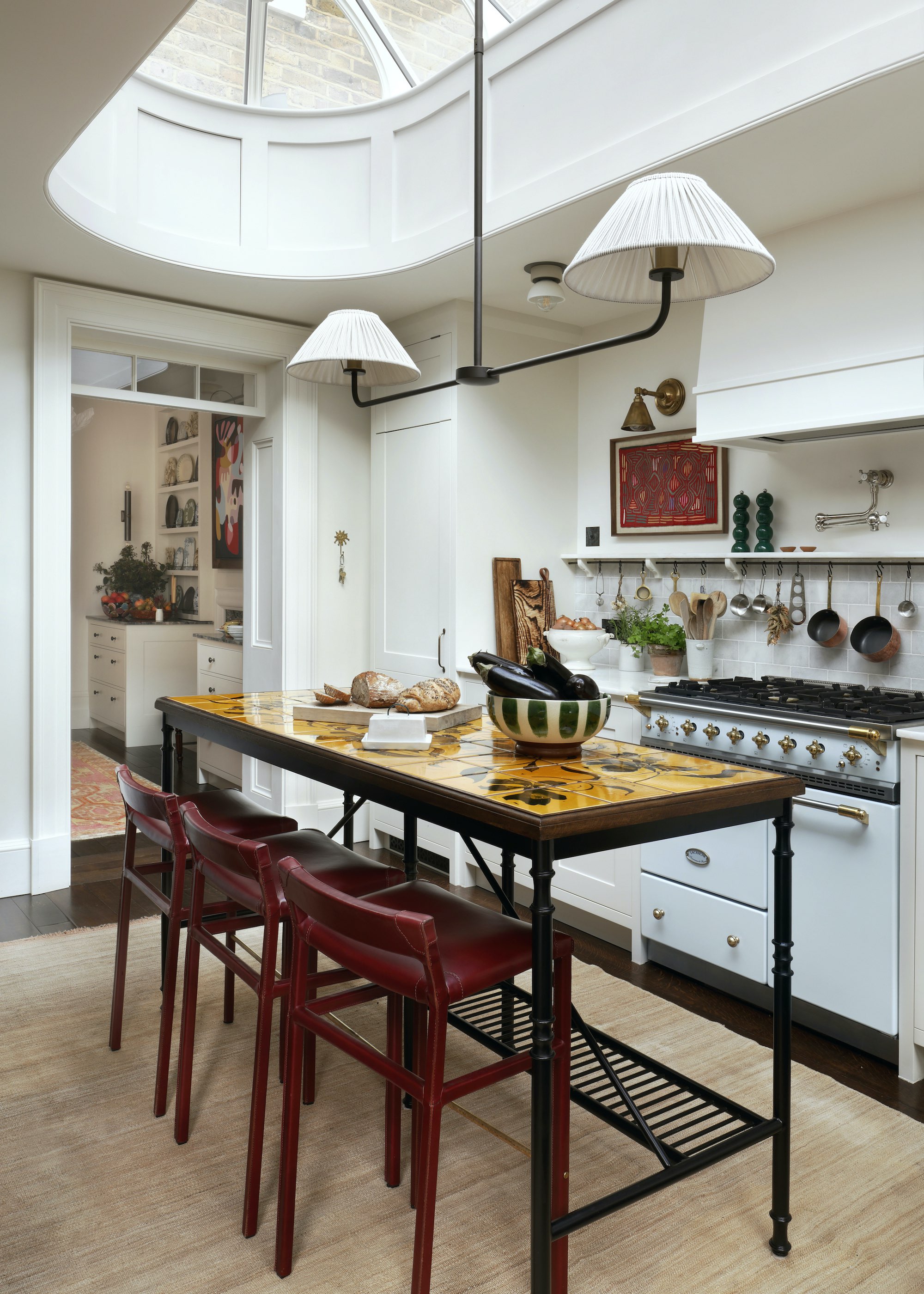 kitchen with metal island and oval roof lantern