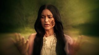 woman with blood on her face looking at her hands