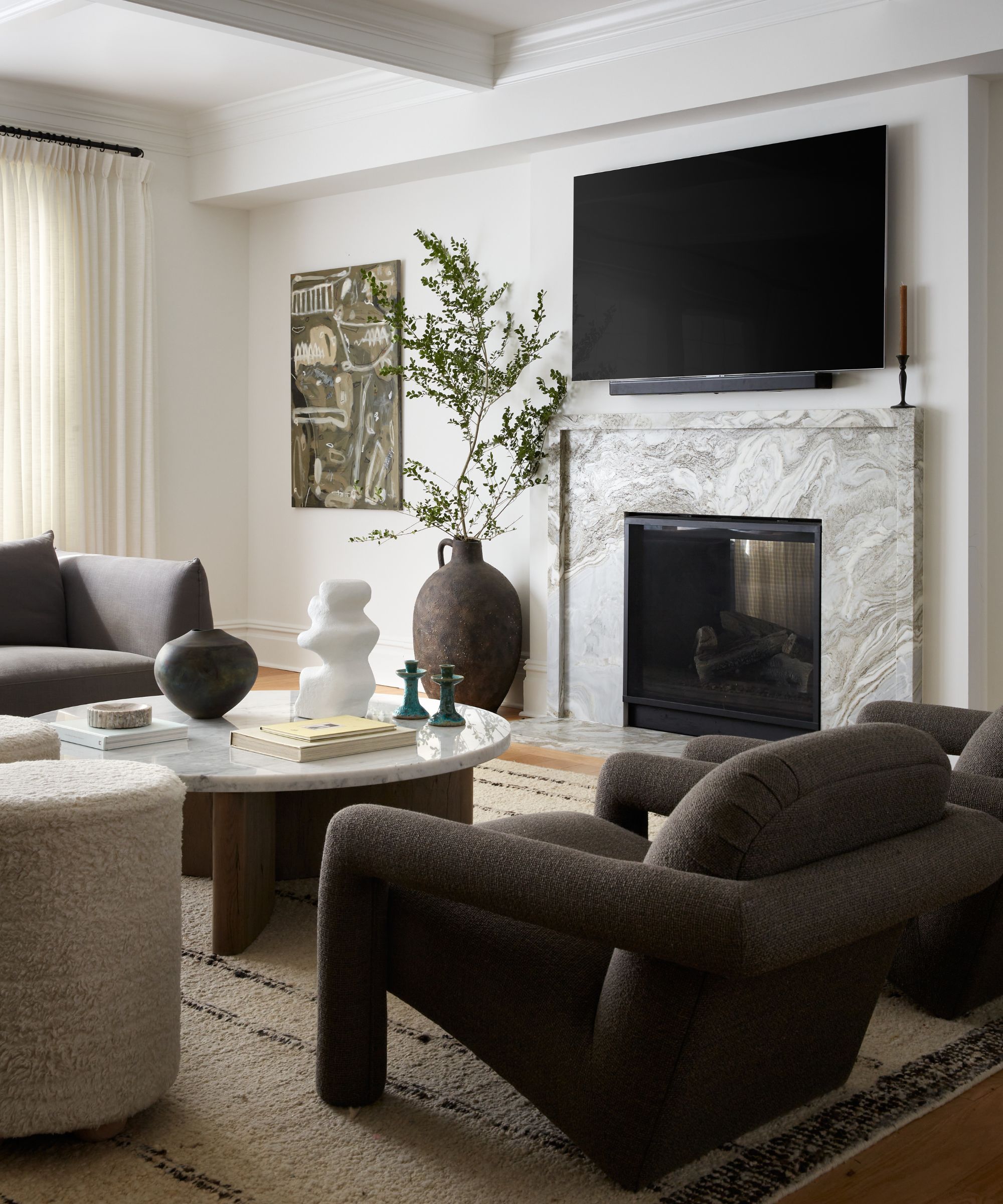 family room with marble fireplace and dark chairs