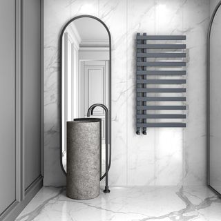 bathtub with towel rack and mirror and washbasin tiles wall and bathroom