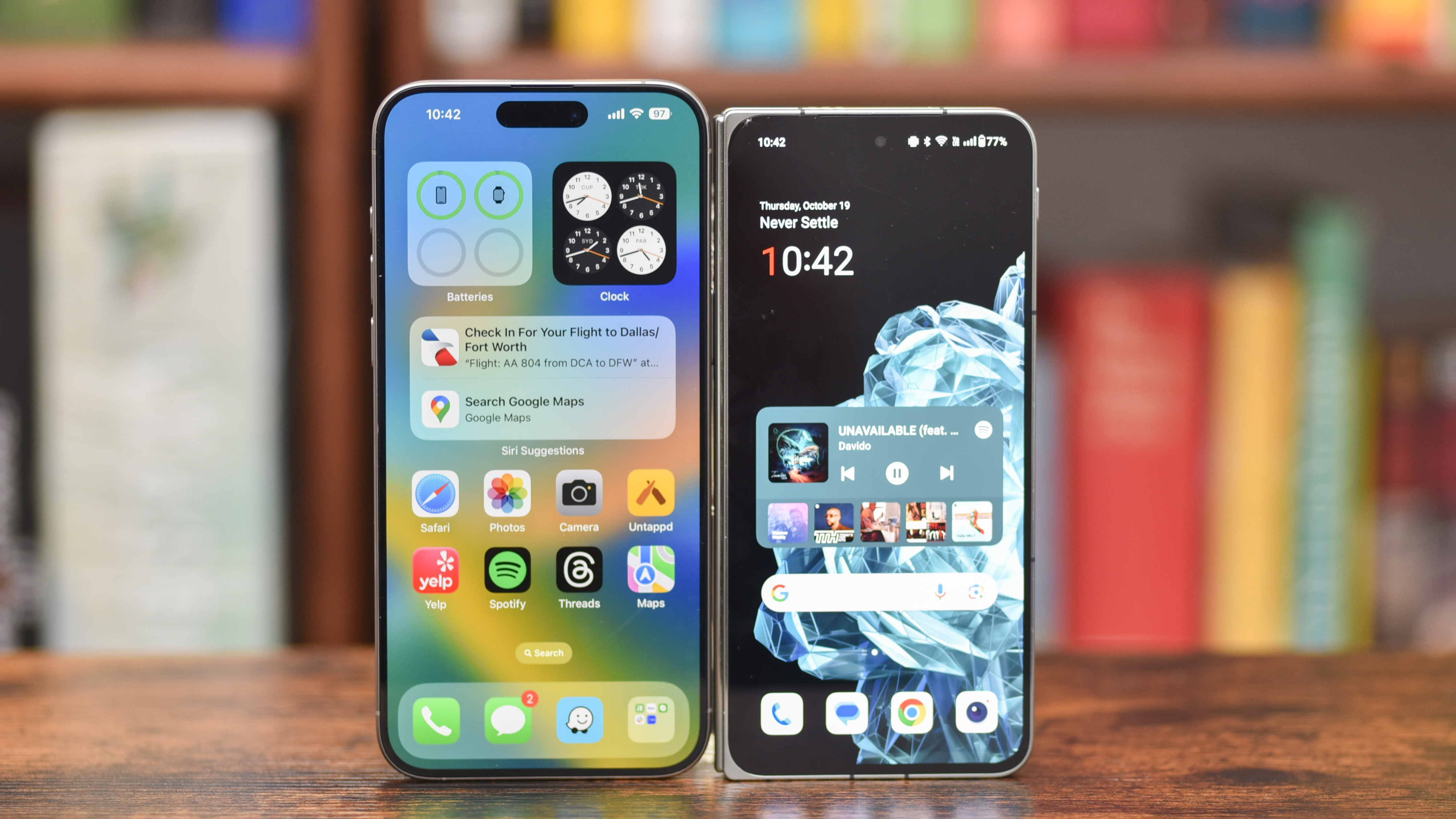 OnePlus Open standing up next to an iPhone 15 Pro Max