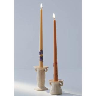 two candle holders in the shape of handled vases