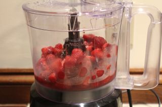 Strawberries in the Oster 10-Cup Food Processor with Easy-Touch ready to be blended into a puree