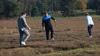 Golfers searching for a lost golf ball